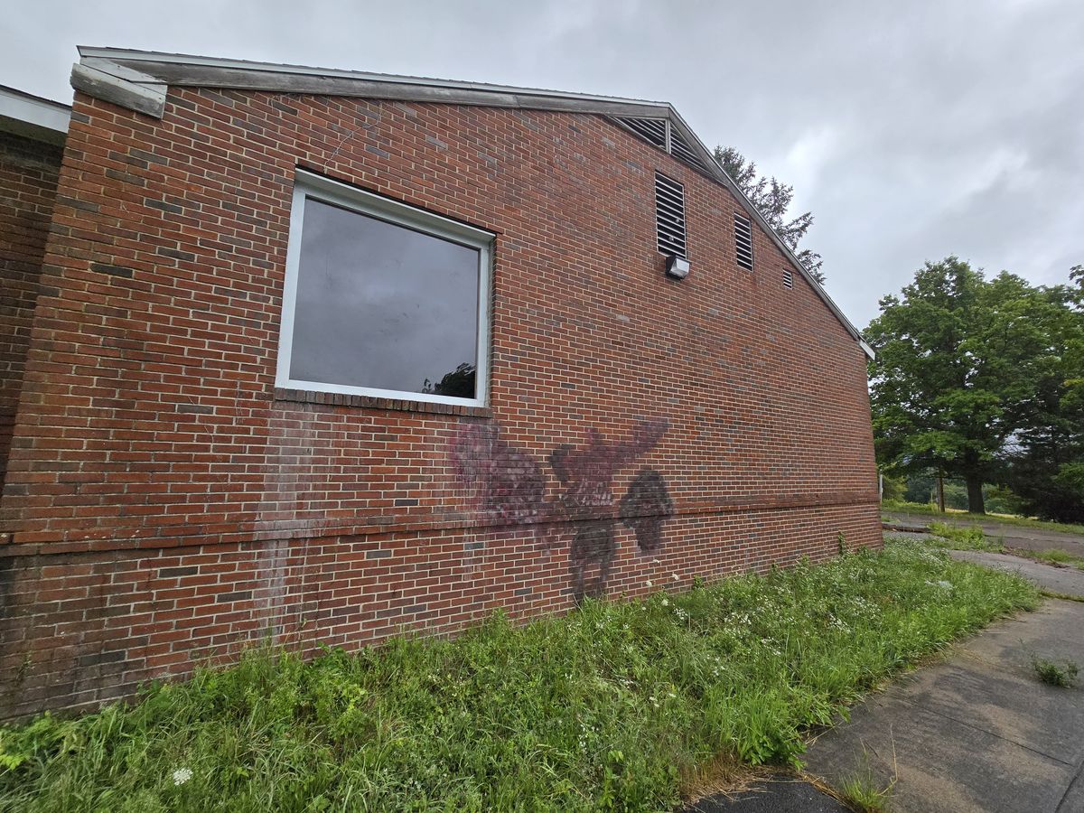 Brick wall with spray paint graffiti